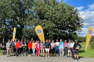 Die Sieger des Golfturnieres auf dem Platz vor einer Sponsorenwand